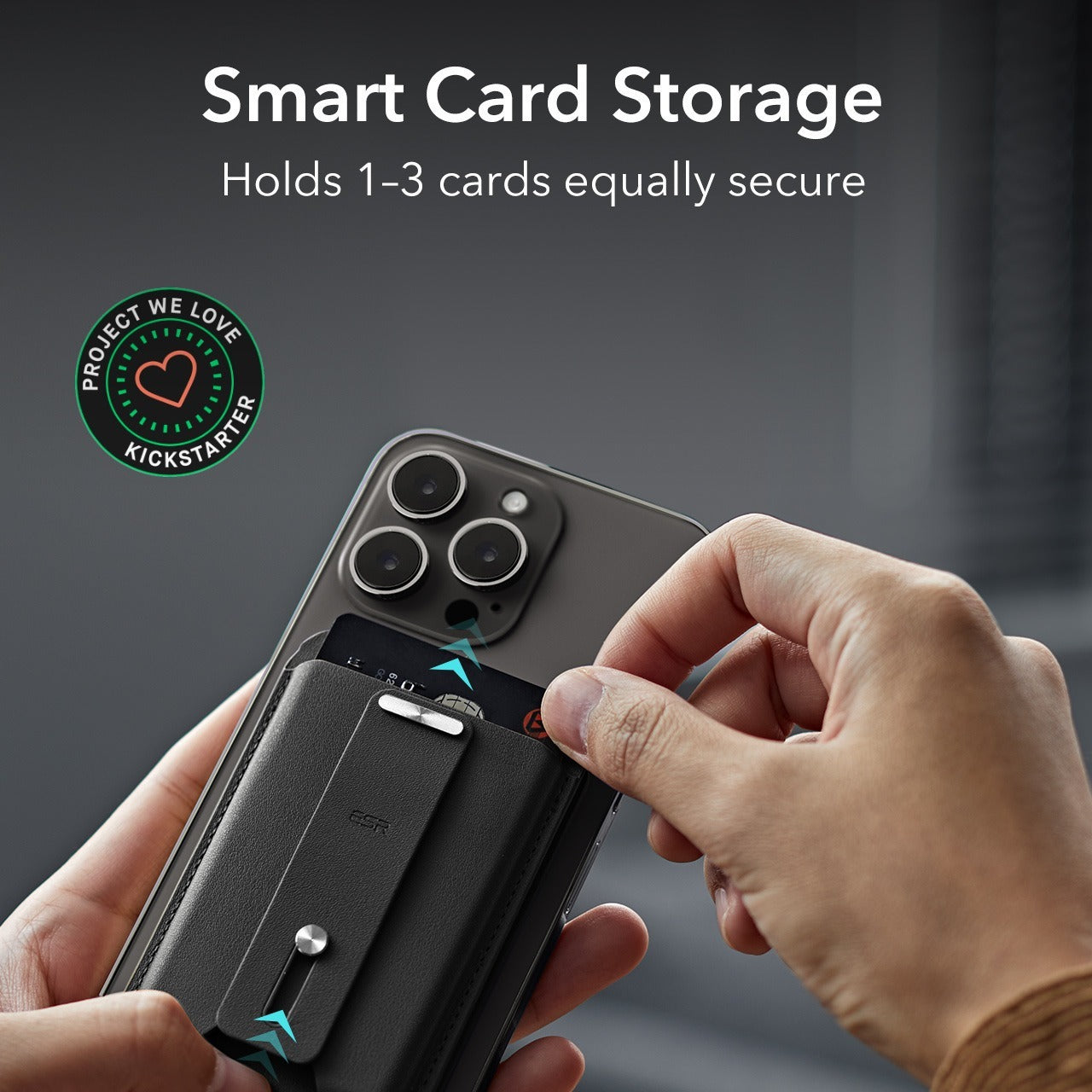A hand holding a black phone using the the black magnetic card holder to hold a credit card