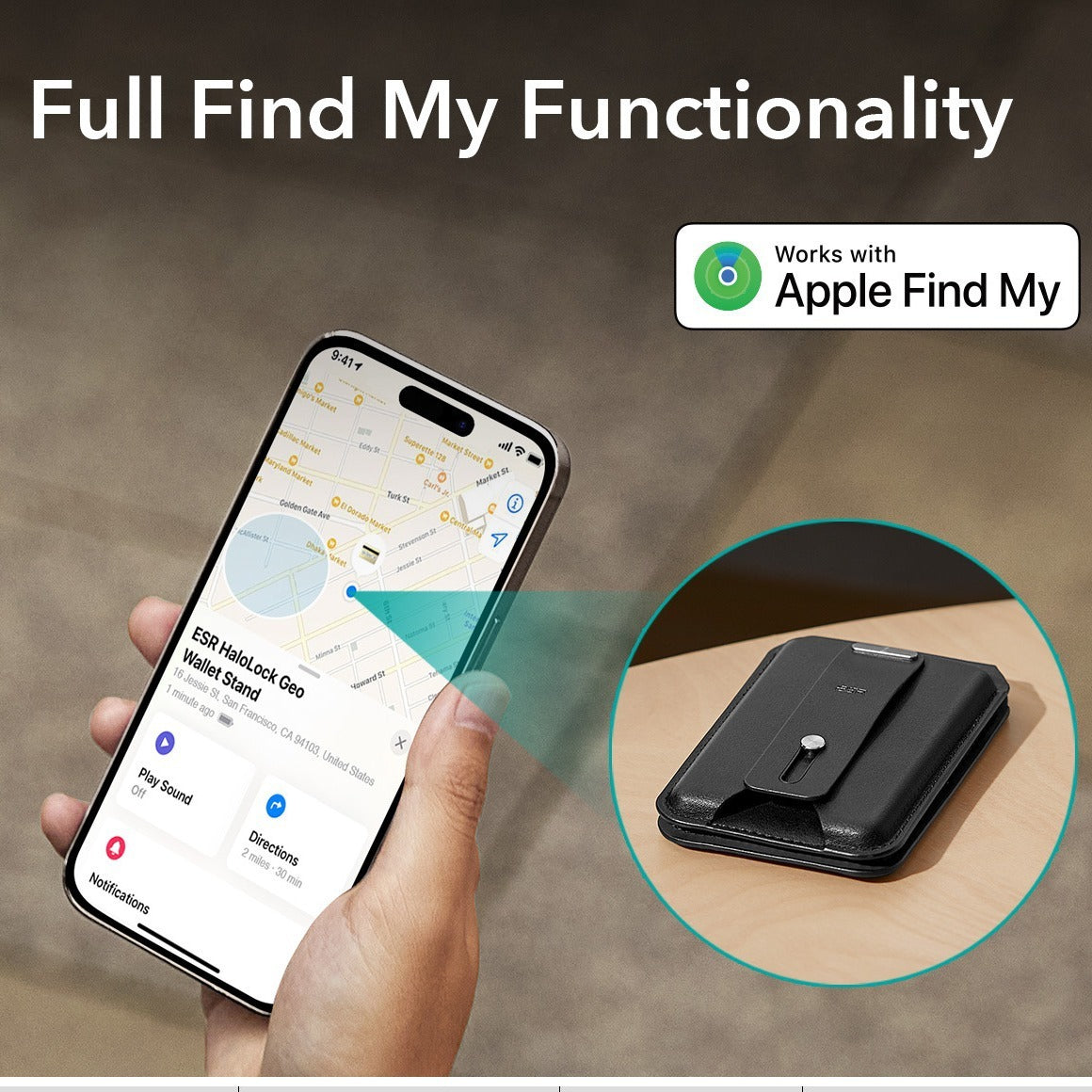 A hand holding a silver phone using the smart app to locate the black magnetic card holder