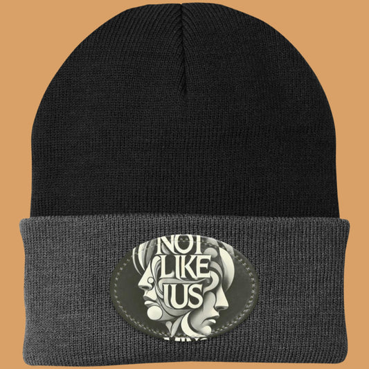 Black Not like us black beanie with dark gray rim peach background