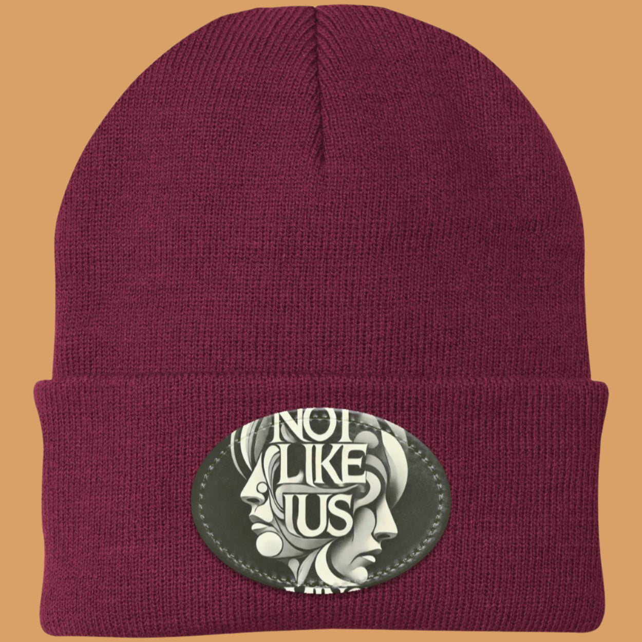 Maroon Not like us black beanie with Maroon rim peach background